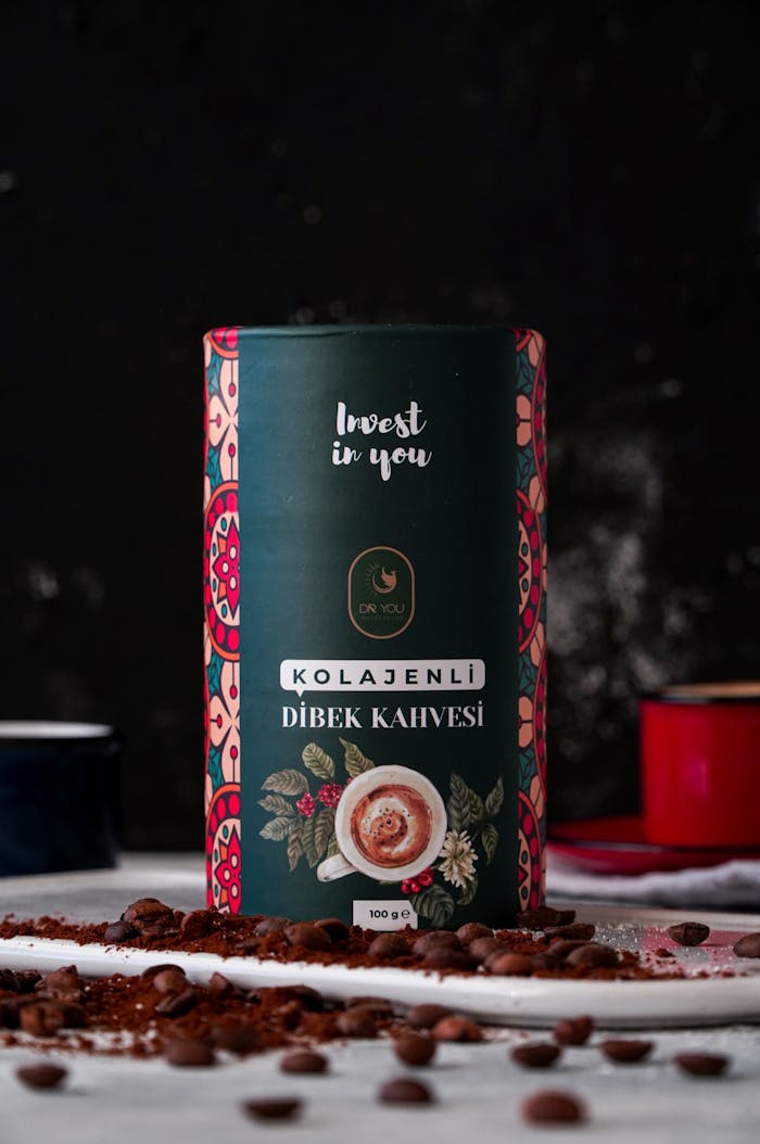 Vibrant Turkish dibek coffee packaging with scattered coffee beans, showcasing a rich traditional design.